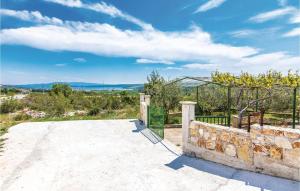 a view from a house with a stone wall at Three-Bedroom Apartment In Slivnica in Slivnica