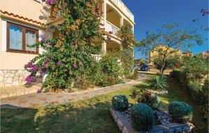 a building with flowers on the side of it at Beautiful Apartment In Povljana in Povljana