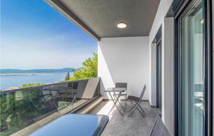 a balcony with chairs and a view of the water at Gorgeous Home In Dramalj in Dramalj