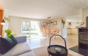 a living room with a couch and a table at Gorgeous Home In Askø With Kitchen in Askø
