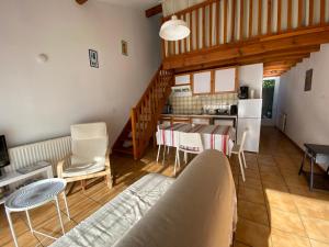 a living room with a table and chairs and a kitchen at Maison à 800m de la plage classée 1 étoile in Capbreton +17 photos