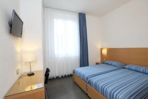 Postel nebo postele na pokoji v ubytování Hotel Genova