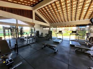 a gym with several treadmills and exercise bikes at Bangalô Exclusivo A5 no Cond Imbassaí Privilege Beira Mar in Imbassai +42 photos