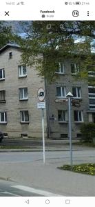 a street sign in front of a large building at Jaama Apartment in Valga