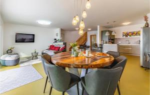 a dining room and living room with a wooden table and chairs at 4 Bedroom Gorgeous Home In Pomer in Pomer