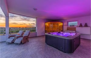 a jacuzzi tub in a room with purple lighting at 4 Bedroom Gorgeous Home In Pomer in Pomer +48 photos