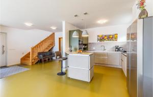 a kitchen with a sink and a desk in a room at 4 Bedroom Gorgeous Home In Pomer in Pomer