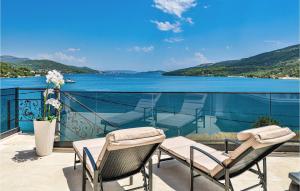 a balcony with chairs and a view of the water at 3 Bedroom Nice Apartment In Marina in Marina