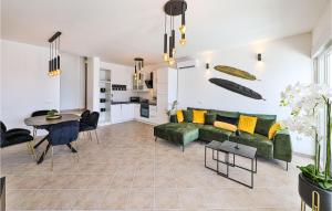 a living room with a green couch and a table at 3 Bedroom Nice Apartment In Marina in Marina