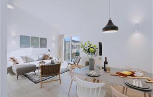a kitchen and living room with a table and chairs at Beach Front Home In Lembruchdümmer See in Lembruch
