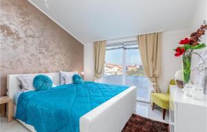 a bedroom with a blue bed and a window at Beautiful Home In Pula With Jacuzzi in Vintijan +54 photos