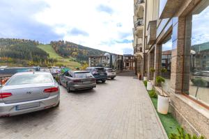 un grupo de coches aparcados delante de un edificio en MARION Family Resort, en Bukovel 39 fotos más