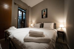 a bedroom with two beds with towels on them at Kokkovos Guesthouse Arachova in Arachova