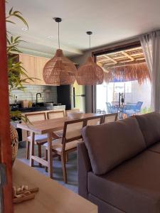 a kitchen and living room with a table and chairs at Casa Flor São Miguel dos milagres 11 in Barra do Camaragibe