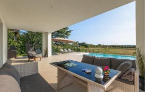 a patio with a couch and a table and a pool at Villa Auri in Pula