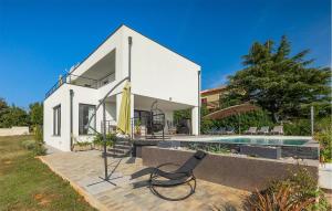 a white house with a pool and a chair at Villa Auri in Pula +43 photos