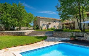 a swimming pool in front of a house at Villa Roveria in Butkovići