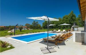 a swimming pool with chairs and an umbrella next to a pool at Villa Roza-Dolinci in Sveti Petar u Šumi