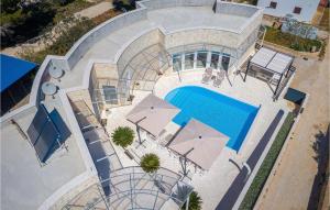 an overhead view of a swimming pool with umbrellas at Feriatum Lissa in Zadar