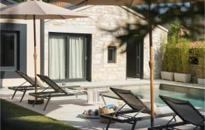 un groupe de chaises et de parasols à côté d'une piscine dans l'établissement Villa Bino&Marija, à Poreč