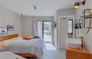 a bedroom with a bed and a sink and a mirror at Villa Casa Juno in Poreč