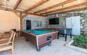 a patio with a pool table and a tv at Lovely Home In Bribir in Bribir