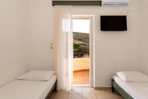 Postel nebo postele na pokoji v ubytování Elpis Studio Apartments