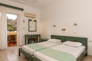 Postel nebo postele na pokoji v ubytování Elpis Studio Apartments