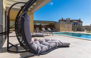 a swing on a patio next to a swimming pool at Villa Bursic in Pula