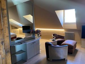 a living room with a mirror and a chair at Casa Andrea - Suite Delux & Design in Aosta