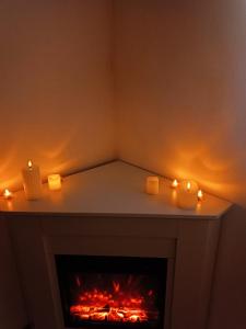 a room with a fireplace with candles on it at Les lauriers roses in Narbonne +5 photos