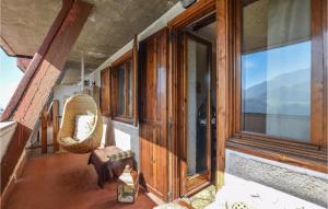 a room with windows and a chair on a balcony at Awesome Apartment In Frabosa Sottana in Frabosa Sottana