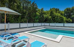 a swimming pool with two chairs and an umbrella at Villa Pervan in Pula +41 photos
