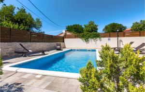 a swimming pool in the backyard of a home at Villa Ivka in Pula