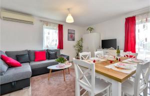 a living room with a table and a couch at Cozy Home In Siljakovina With Sauna in Šiljakovina