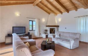 a living room with two couches and a tv at Villa Nino in Rovinj