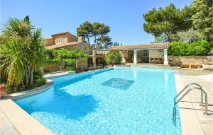 a swimming pool in front of a house at Amazing Home In Orgon in Orgon +42 photos