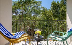two chairs and a table on a balcony at Nice Home In Kraljevica With Wifi in Kraljevica
