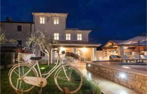 a bike parked in front of a house at night at Villa Elizabeta in Umag