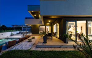 a house with a swimming pool and a patio at Villa Evoque in Bibinje
