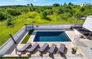 an overhead view of a swimming pool with lounge chairs at Villa Evoque in Bibinje