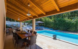 a patio with a table and a swimming pool at Villa Tila in Pazin