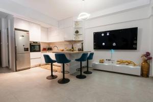 a kitchen with a counter and stools in a room at Serenity apartment in Thessaloniki
