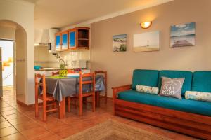 a living room with a couch and a table at Casas do Zé in Odeceixe