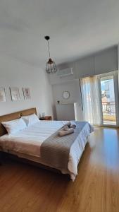 a bedroom with a large bed and a large window at Antonia's city apartment in Ioannina