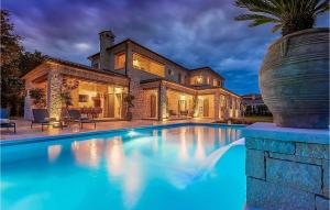 a large swimming pool in front of a house at Villa Nevia in Rovinj