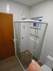 a bathroom with a shower with a glass door at Iguassu Falls Refuge - Cataratas do Iguassu - Paraguai - Argentina in Foz do Iguaçu +38 photos