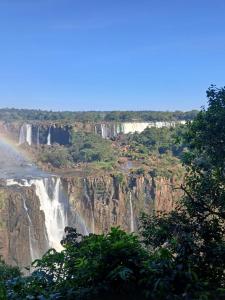 a view of a waterfall on the side of a mountain at Iguassu Falls Refuge - Cataratas do Iguassu - Paraguai - Argentina in Foz do Iguaçu