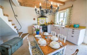 a kitchen with a wooden table and a chandelier at Villa Amore in Bribir
