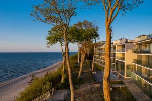 a view of the ocean from the balcony of a building at Apartament Holiday Gold in Rewal